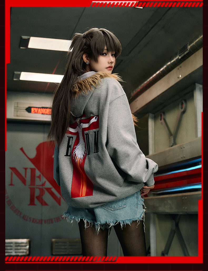 Young woman in MEDM x EVA streetwear sweatshirt, showcasing urban fashion with anime flair.