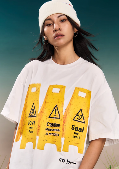 YADcrew “Love Caution Seal” Print Tee | Face 3 Face