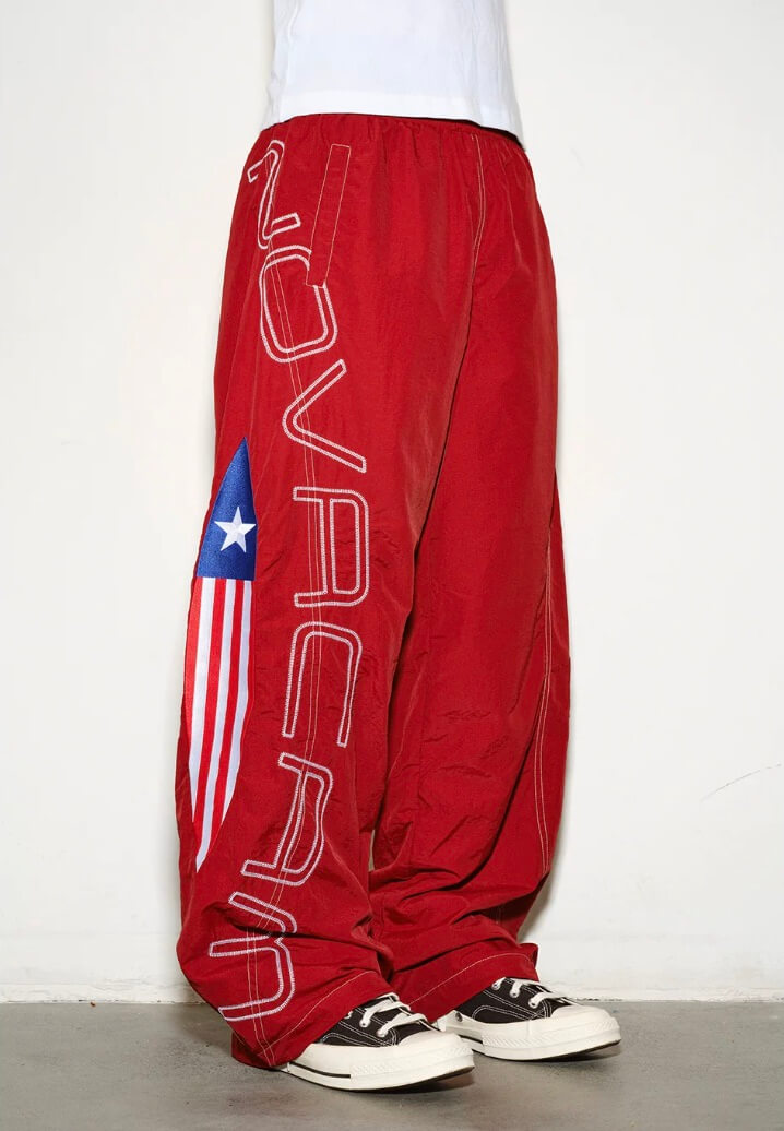 NOVACAM Logo Embroidered Nylon Curved Baggy Track Pants | Face 3 Face