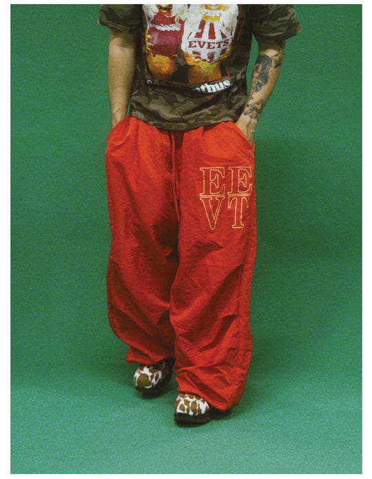 EVETS Orange Logo Print Nylon Baggy Track Pants | Face 3 Face