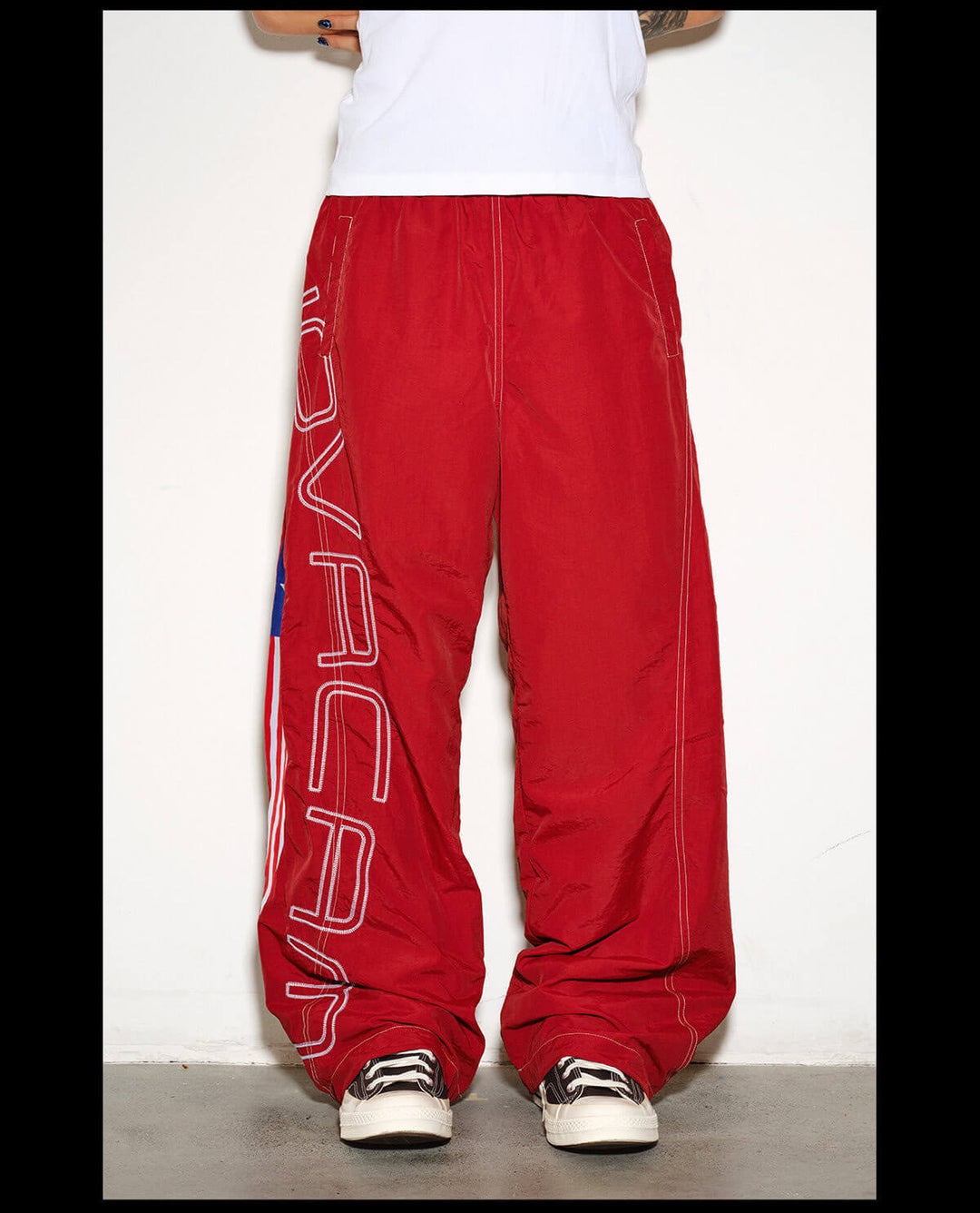 NOVACAM Logo Embroidered Nylon Curved Baggy Track Pants | Face 3 Face