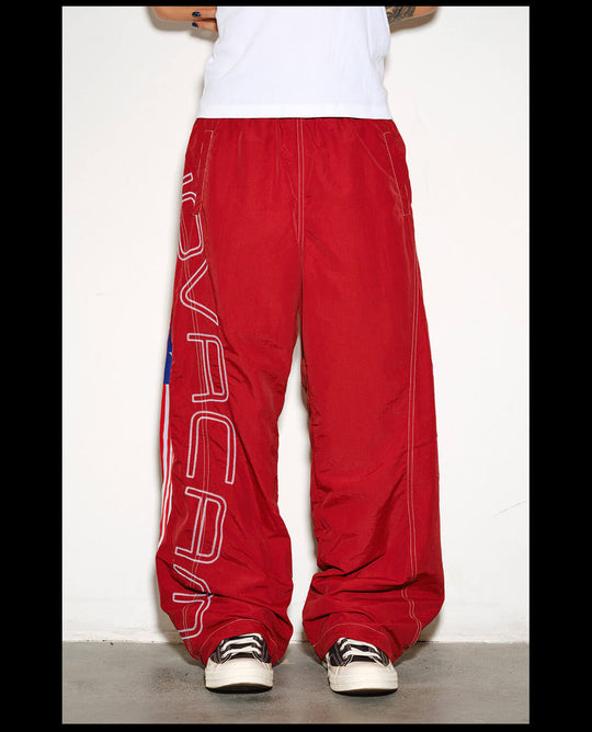 NOVACAM Logo Embroidered Nylon Curved Baggy Track Pants | Face 3 Face