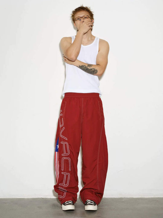 NOVACAM Logo Embroidered Nylon Curved Baggy Track Pants | Face 3 Face