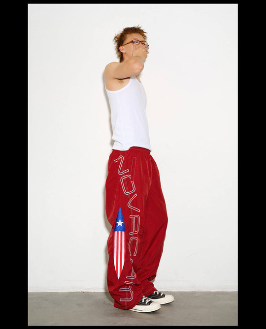 NOVACAM Logo Embroidered Nylon Curved Baggy Track Pants | Face 3 Face