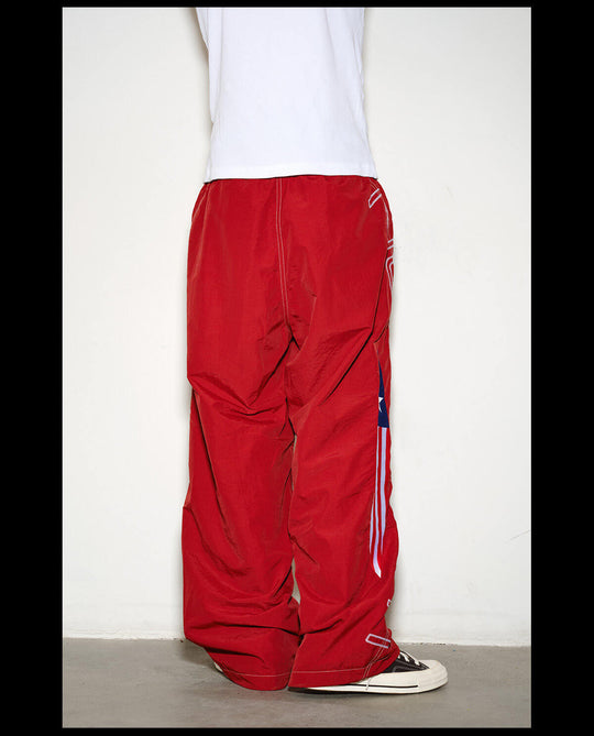 NOVACAM Logo Embroidered Nylon Curved Baggy Track Pants | Face 3 Face