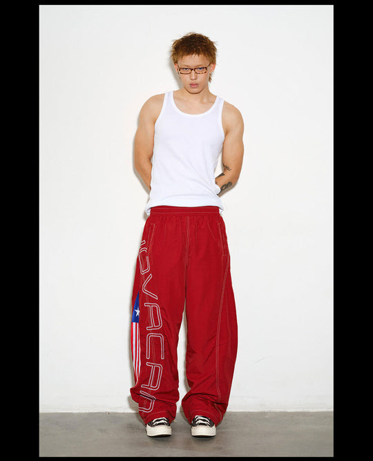 NOVACAM Logo Embroidered Nylon Curved Baggy Track Pants | Face 3 Face