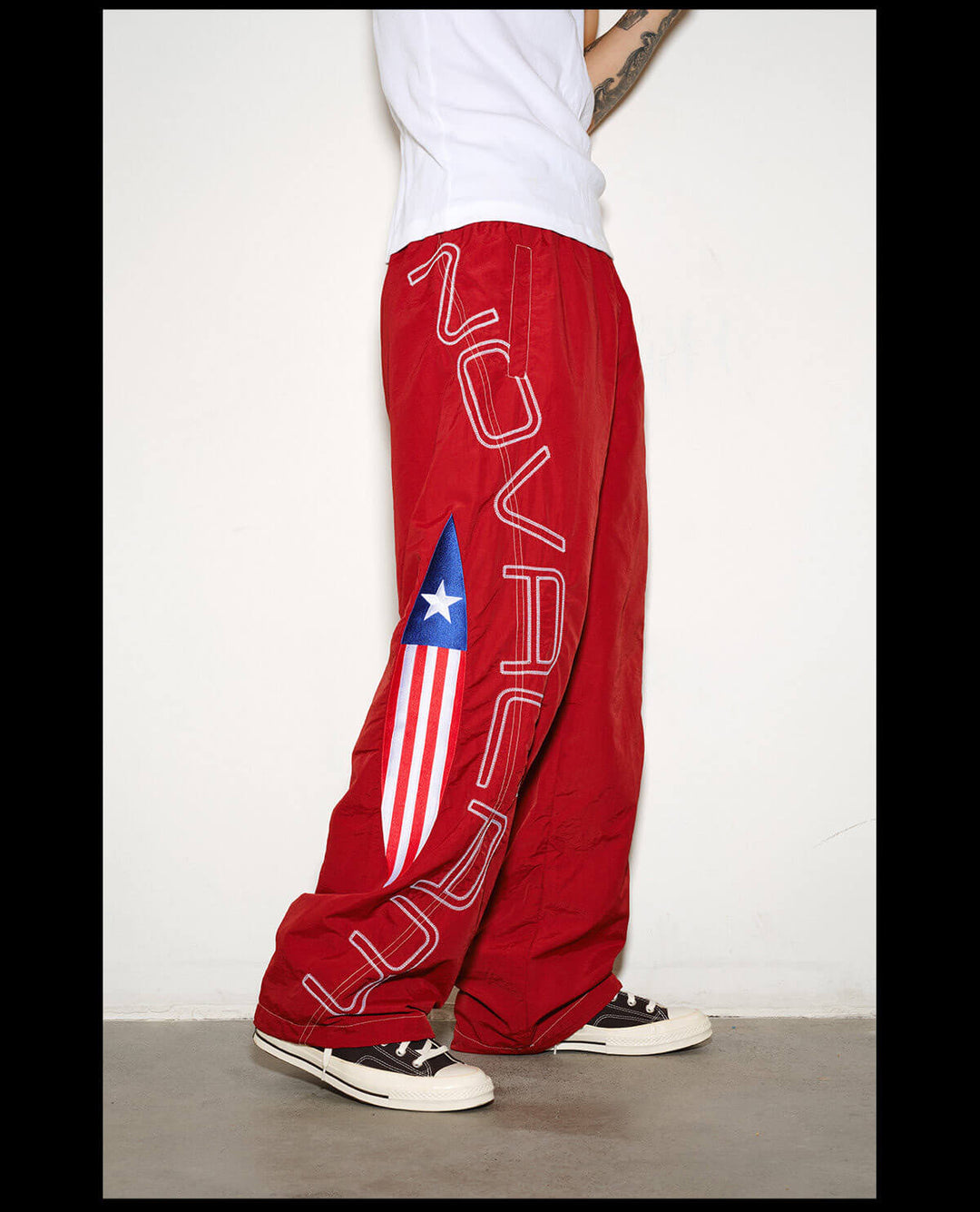 NOVACAM Logo Embroidered Nylon Curved Baggy Track Pants | Face 3 Face