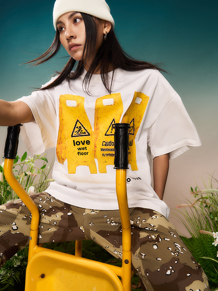 YADcrew “Love Caution Seal” Print Tee | Face 3 Face